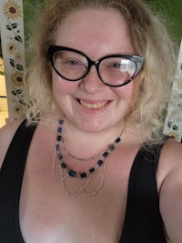 a woman wearing glasses and a necklace