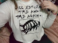 a young girl wearing a t shirt that says'reset time and time again'