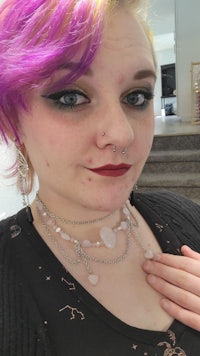 a woman with purple hair posing for a photo