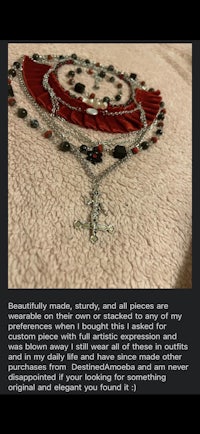 a picture of a necklace with a cross on it