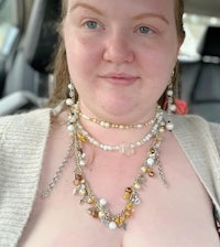 a woman in a car wearing a necklace